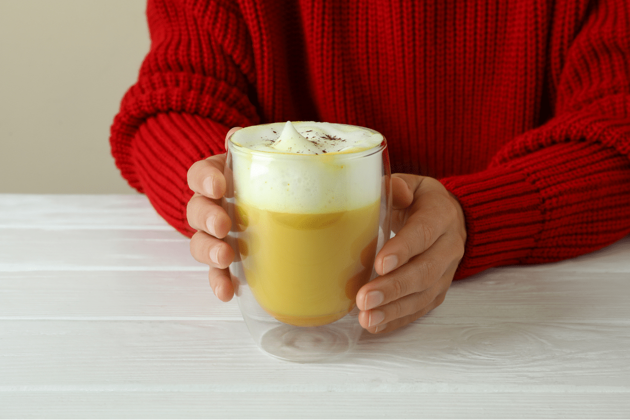 woman holding a spiced pumpkin latte